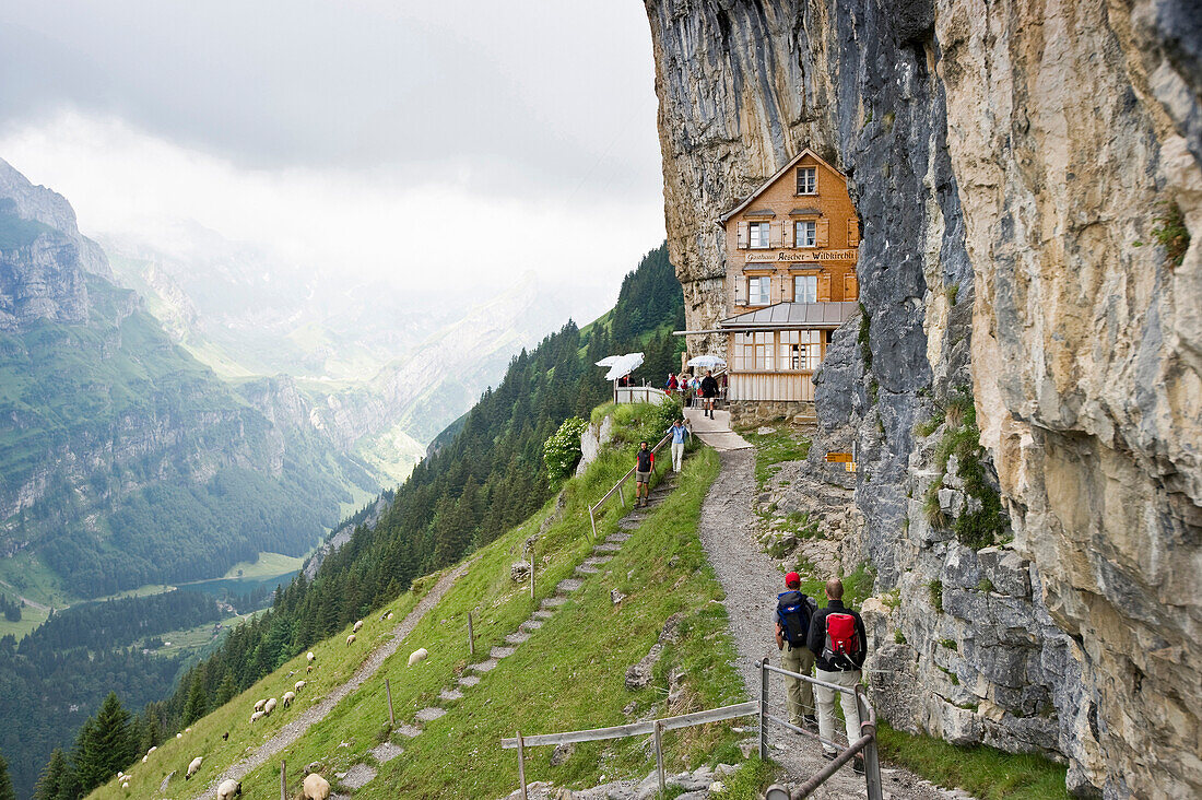 Mountain hikers near mountain inn Aescher, Ebenalp, Alpstein massif, Appenzell Innerrhoden, Switzerland