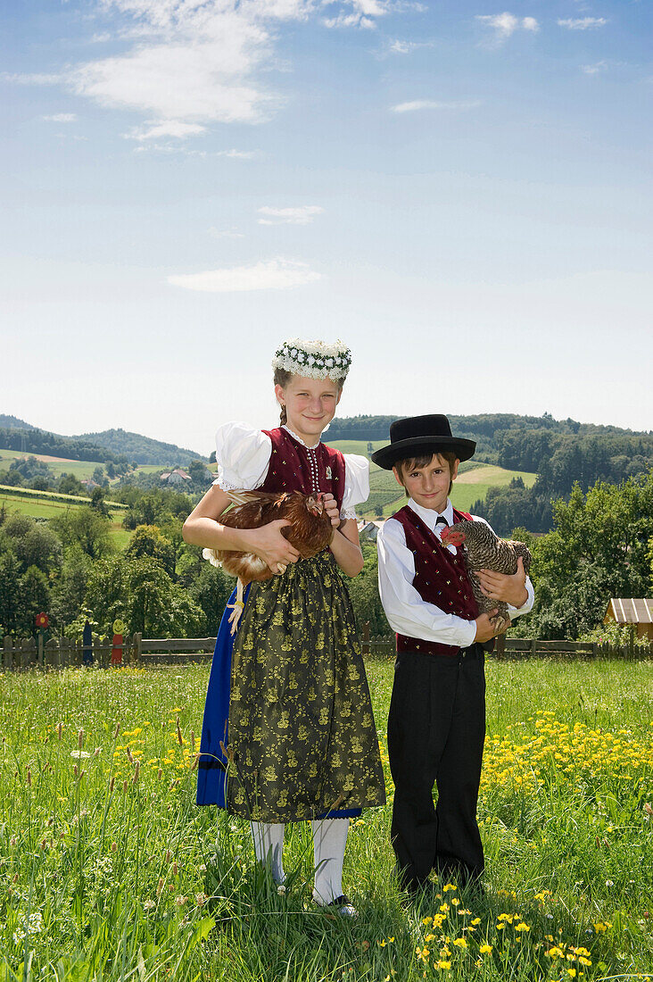 Two children wearing traditional Black Forest clothes, Gottertal, Baden-Wurttemberg, Germany