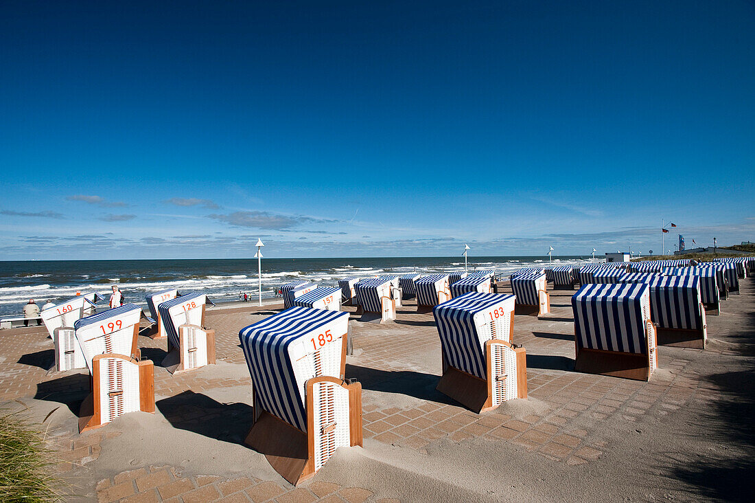 Roofed wicker beach chairs at promenade, Norderney, East Frisian Islands, Lower Saxony, Germany