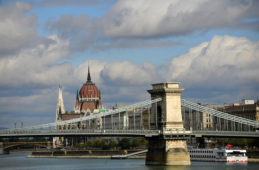 Danube river, House of Parliament and Chain Bridge under clouded sky, Budapest, Hungary, Europe