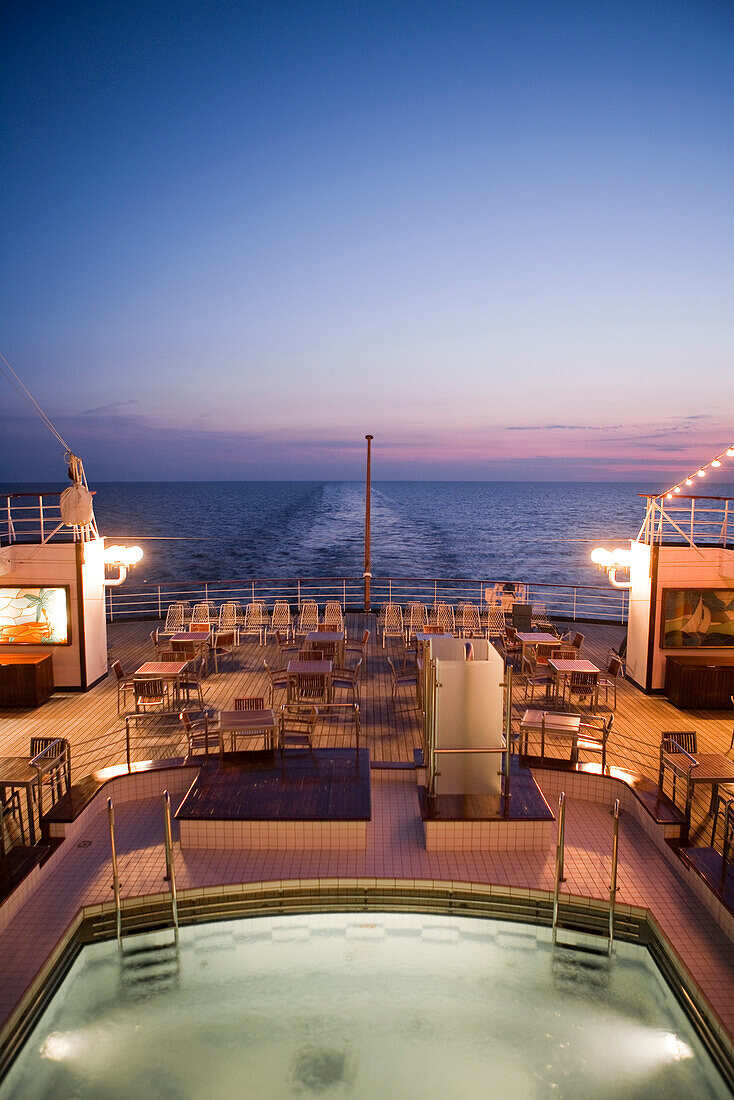 Swimming pool and aft deck aboard cruise ship MS Astor (Transocean Kreuzfahrten) at dusk, Baltic Sea, near Denmark