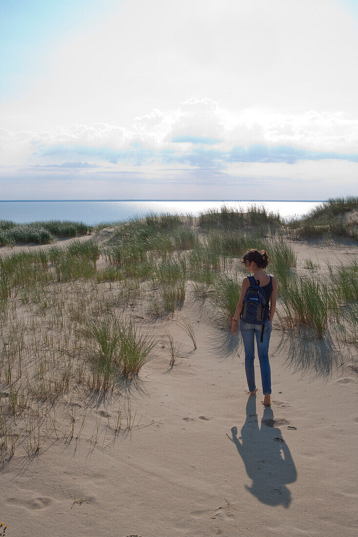 Woman strolls along sand dune on Curonian Spit [MR], near Klaipeda, Klaipedos, Lithuania