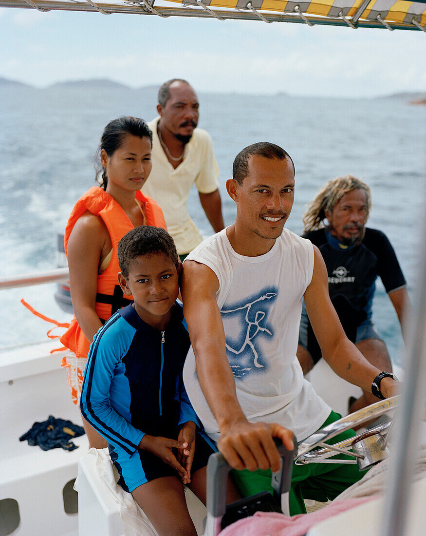 Family on a boat of Liberty Charter snorkeling tour, to Felicité island with octopus hunter Alvis Jean and captain Jonathan Waye-Hive, La Digue and Inner Islands, Republic of Seychelles, Indian Ocean