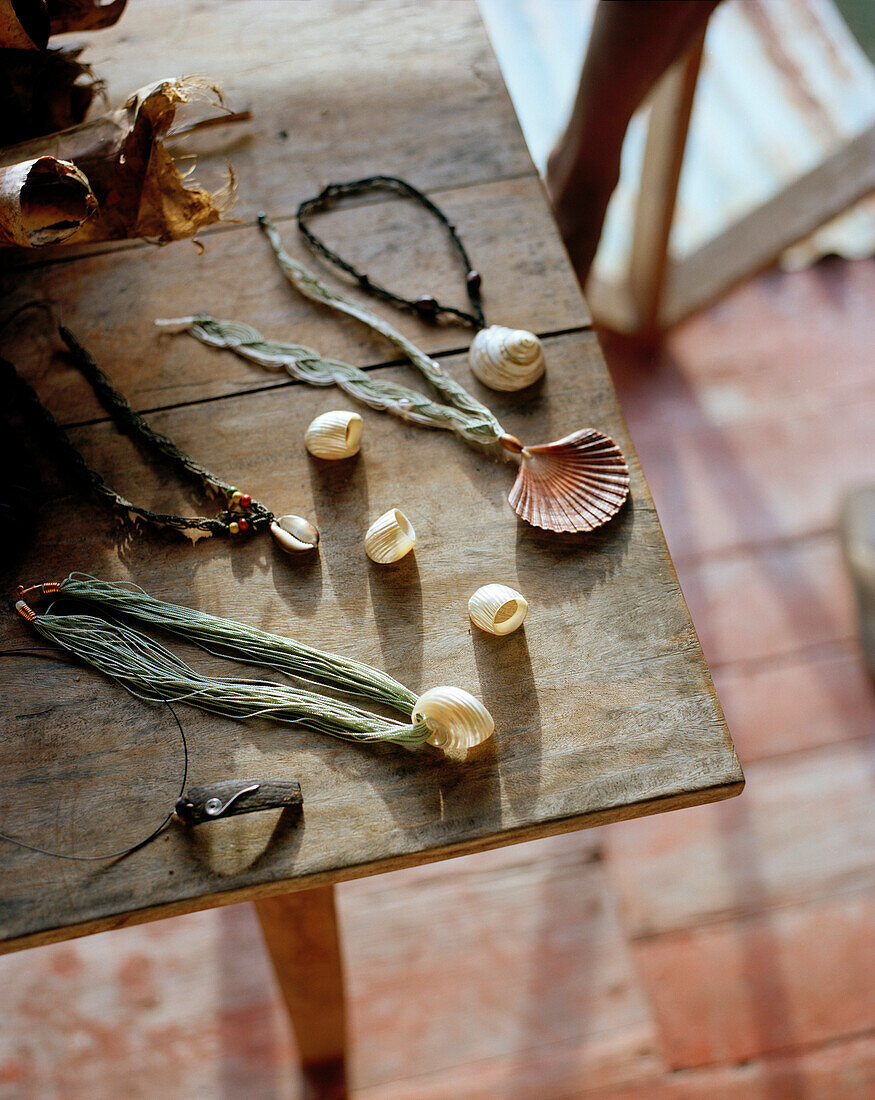 Handmade jewellery on wooden table, La Passe, La Digue and Inner Islands, Republic of Seychelles, Indian Ocean