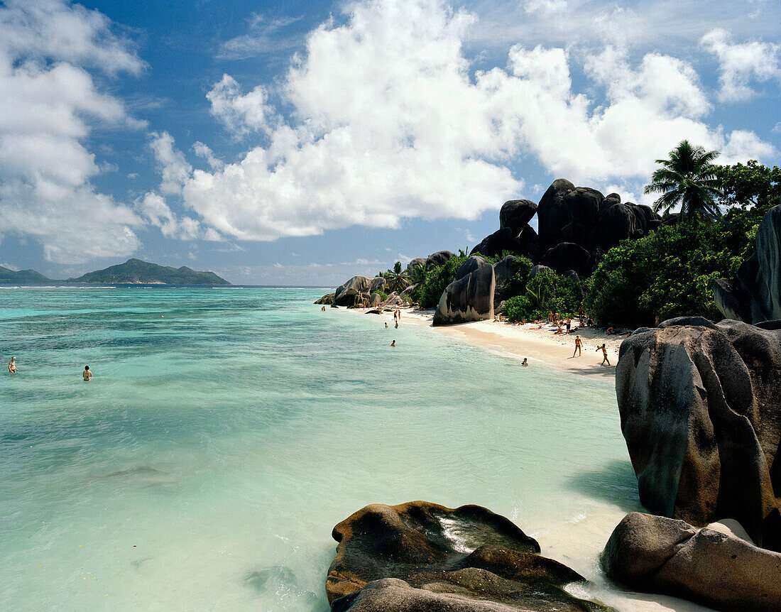 Touristen am weltberühmten Strand Anse Source d'Argent mit Granitfelsen, südwestliches La Digue, La Digue and Inner Islands, Republik Seychellen, Indischer Ozean