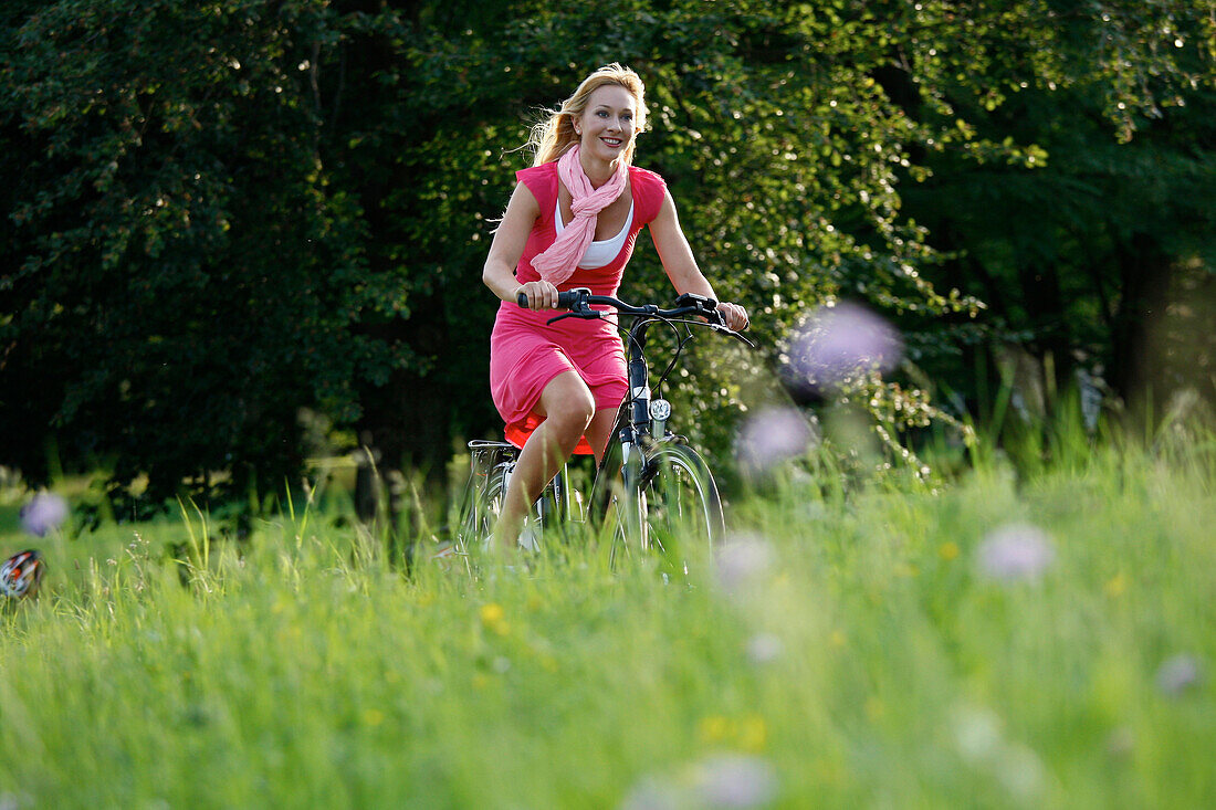 Woman cycling through Rosenstein Park, bike tour, e-bike, Rosenstein Park, Stuttgart, Baden-Wurttemberg, Germany