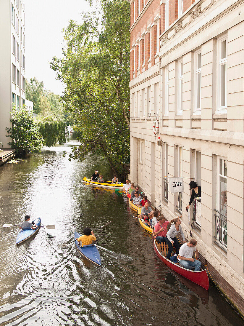 Canoes waiting in front of a cafe on a Alster canal, Hanseatic City of Hamburg, Germany