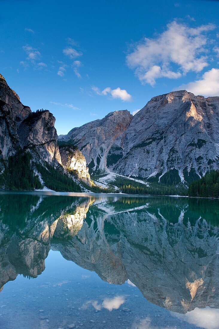 Reflection of mountains on lake Pragser Wildsee at dusk, Nature Park Fanes Sennes Prags, South Tyrol, Alto Adige, Italy, Europe