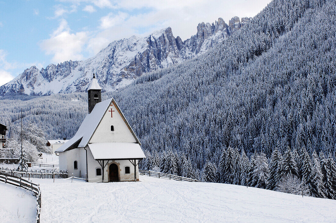Sebastian chapel in snowy mountain scenery, Latemar Eggental valley, Dolomites, South Tyrol, Alto Adige, Italy, Europe