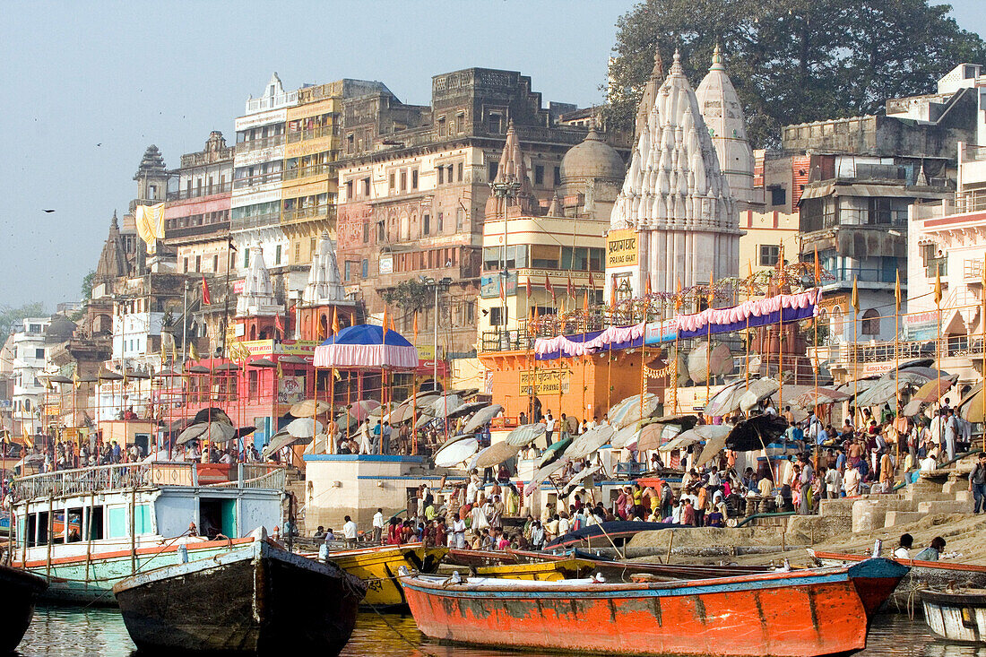 Hindu pilgrims and boats at River Ganges, Varanasi, India