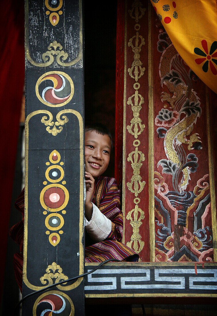 Bhutanese boy spectator in a window, Thimpu, Bhutan