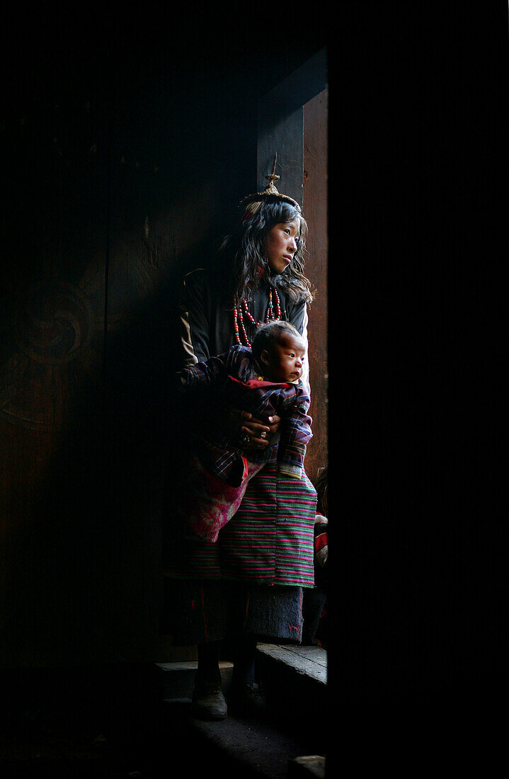 A Layap girl holding a baby in Koina, Laya, North West Bhutan