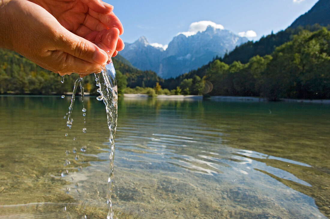 Washing hands at Lake Jasna, Kranjska Gora, Slovenia.