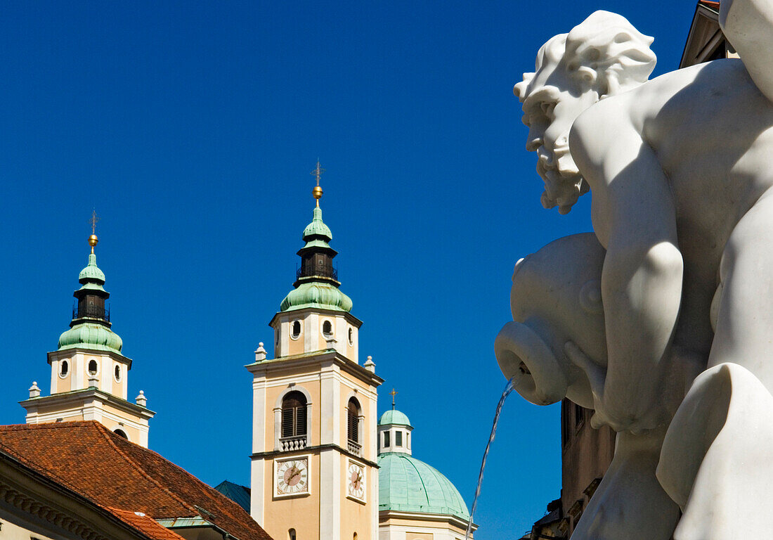 Fountain statue with St. Niklas Cathedral in the background, Ljubljana, Slovenia.