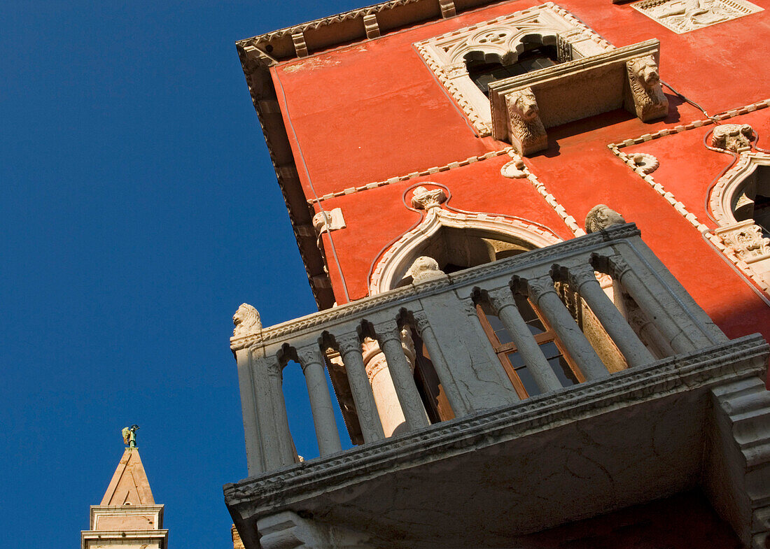 Detail of Venetian house with church spire in the background, Piran, Slovenia.