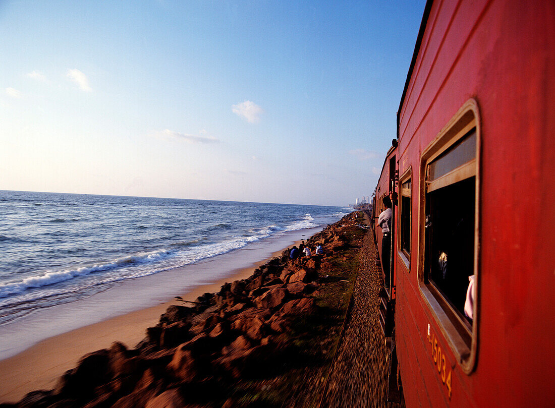 Train traveling to Columbo at dusk, Sri Lanka