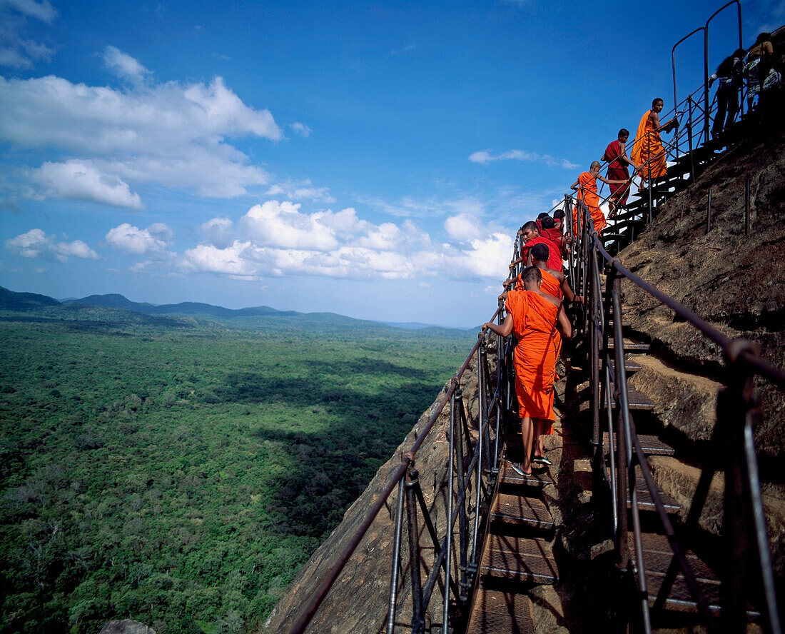 Buddhist monks climbing steps of Sigiriya Lion Rock Fortress, Sigiriya, North Central Province, Sri Lanka