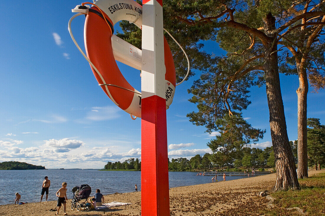 People enjoying the lakeside, Lake Malaren, Eskilstuna, Sweden.