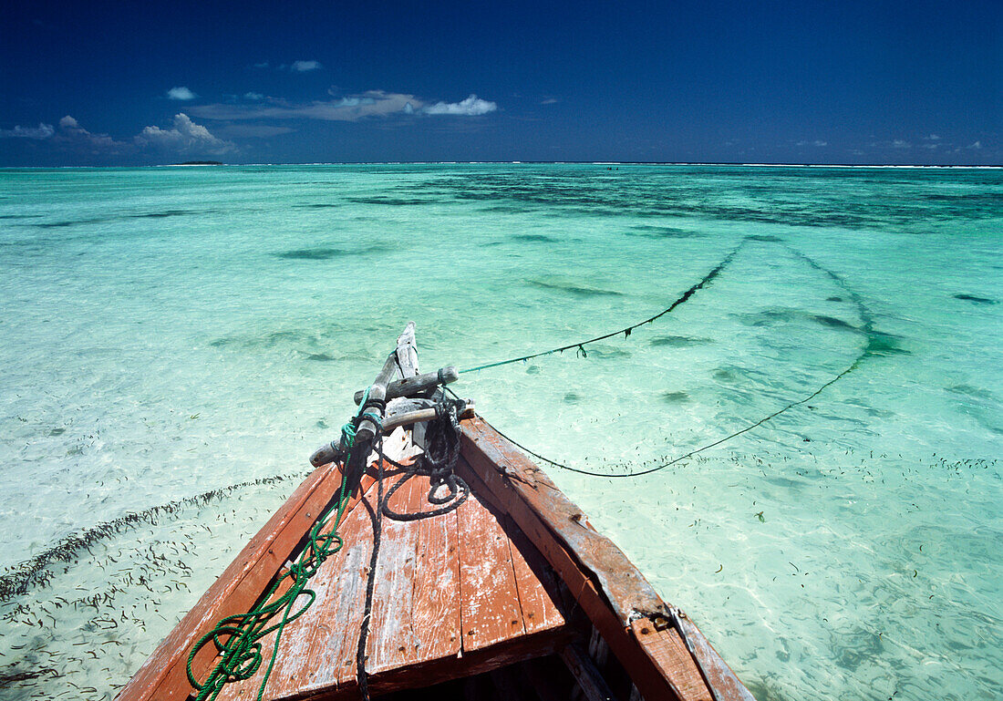 Old boat sitting in the shallow water off Matemwe on the north east coast of Zanzibar, Zanzibar, Tanzania, Africa