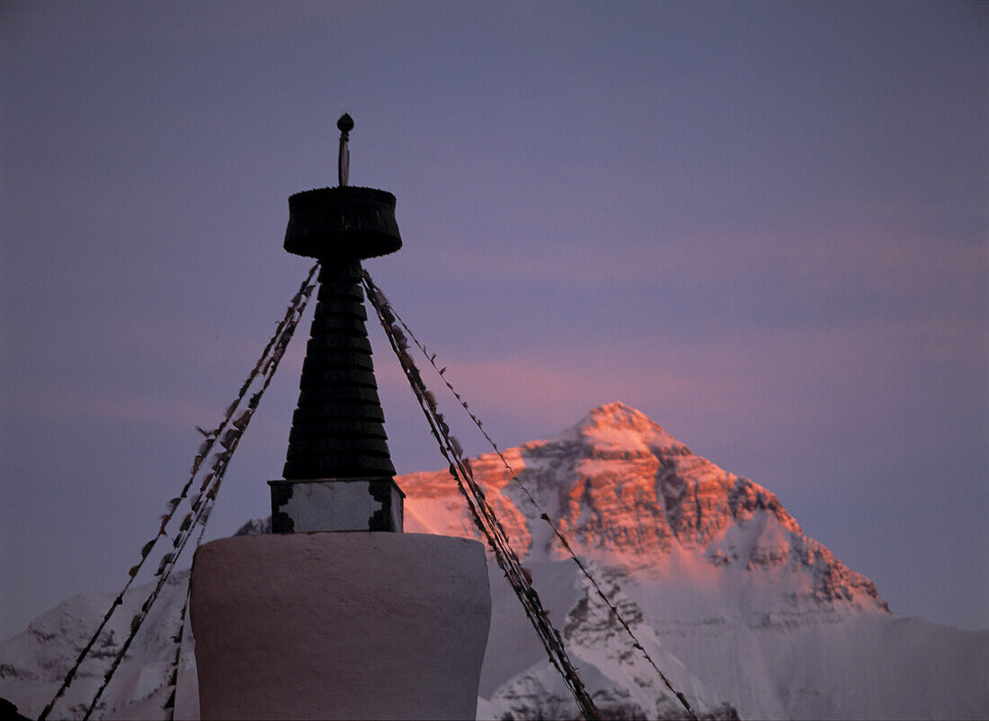 Chorten beside Ronbuk Monastery in front of Mt. Everest at dusk, Tibet.