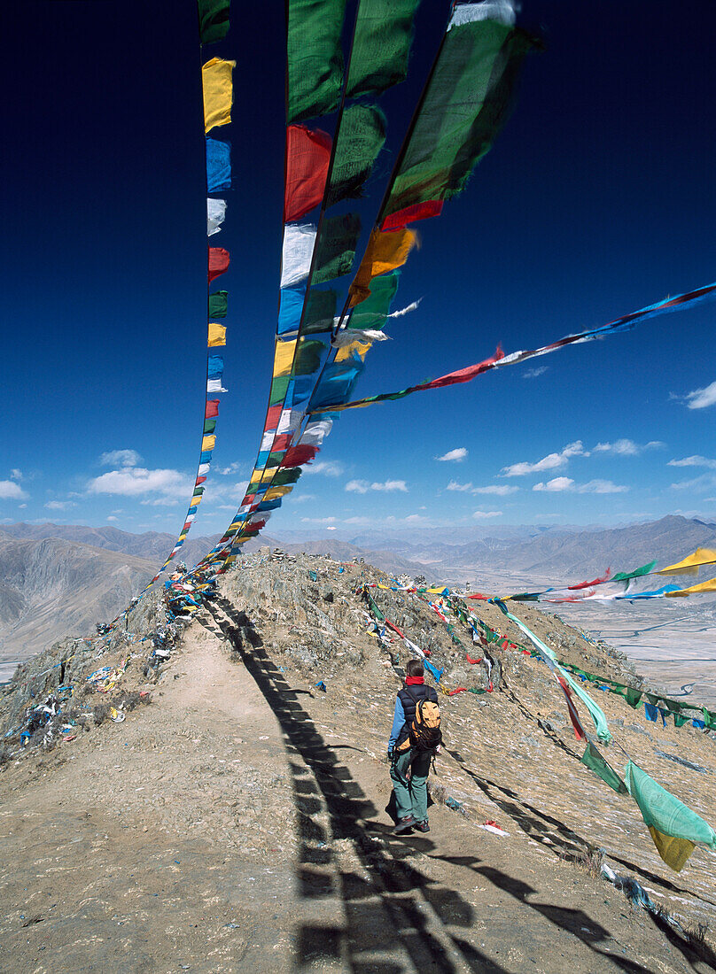 Woman walking along ridge, Tibet