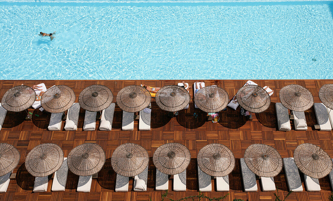 Man swimming in pool by sunloungers, Aerial View, Antalya, Turkey