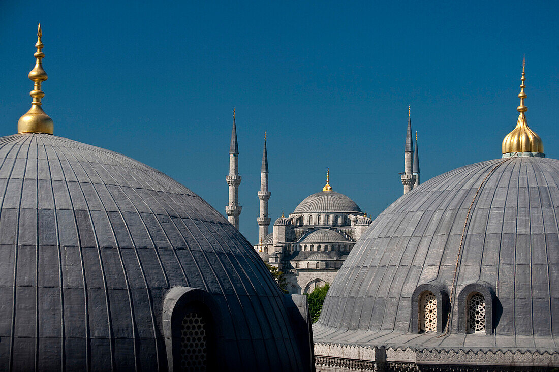 Looking across the domed rooves of the Haghia Sophia to the Sultanahmet or Blue Mosque, Istanbul, Turkey.