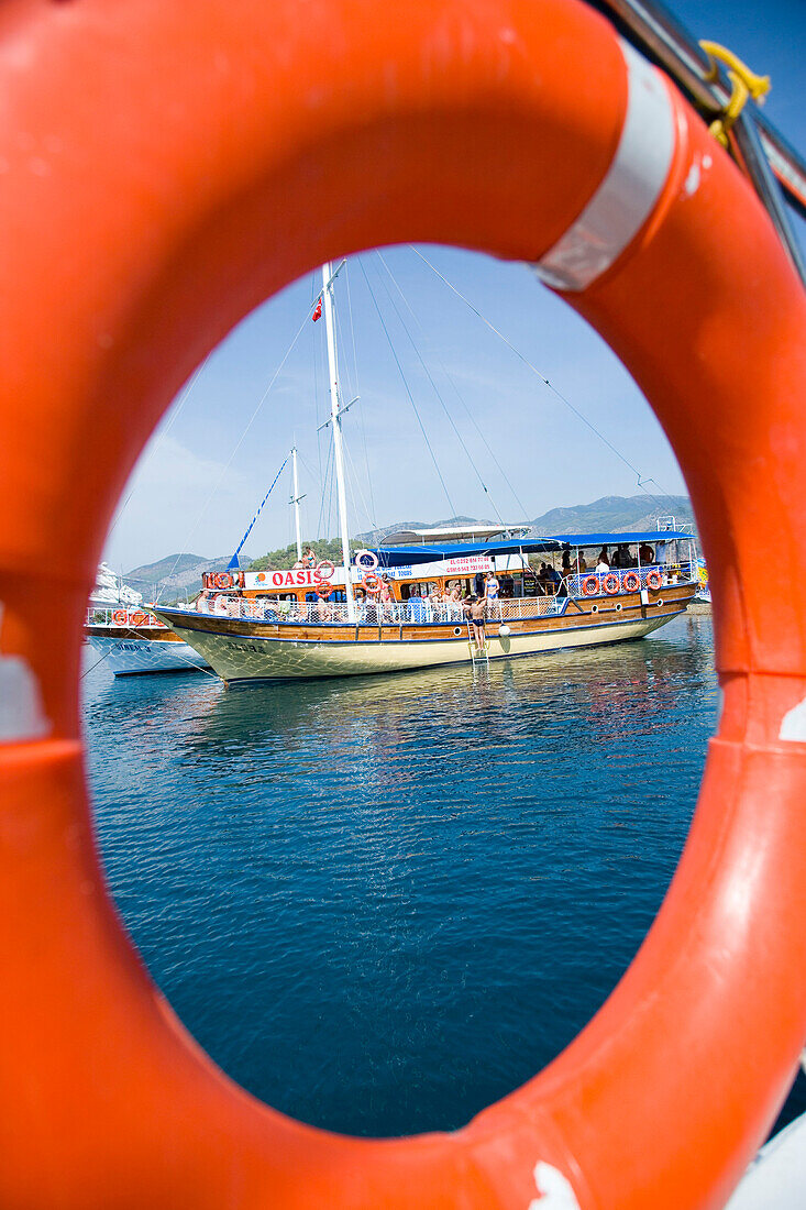 View of moored boats through the life ring from another boat, Fethiye Bay, Turkey