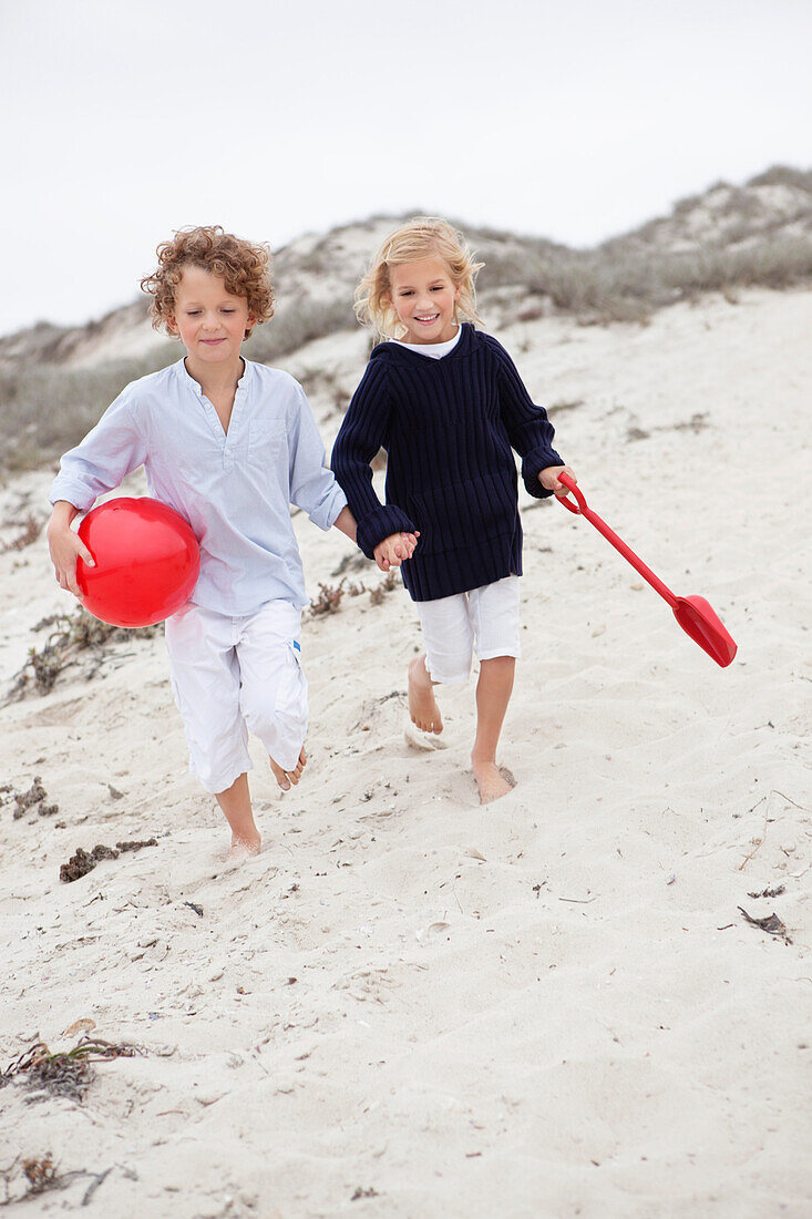 Children running on sand at beach
