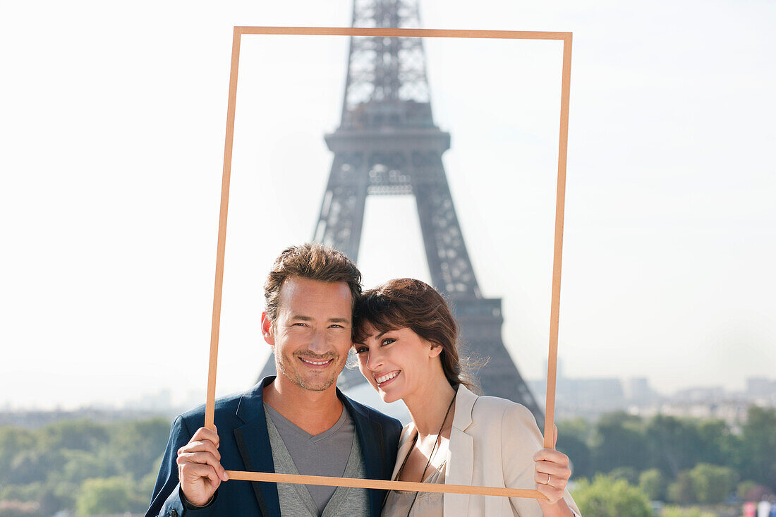 Portrait of a couple framing their dream vacation with Eiffel Tower, Paris, Ile-de-France, France