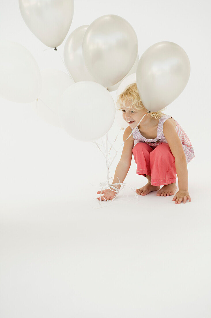 Girl playing with balloons