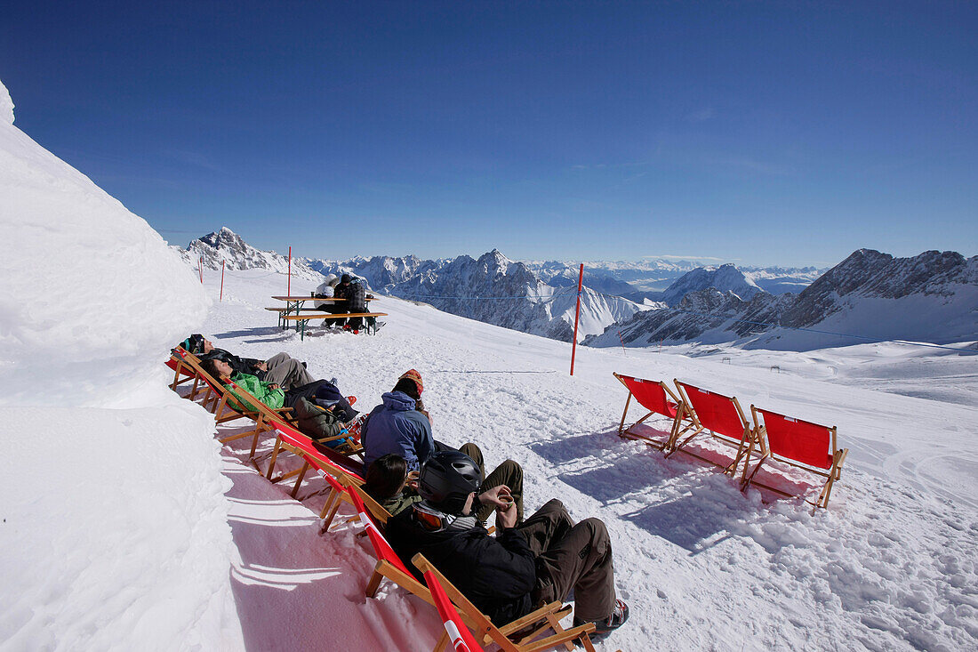 Guests sunbathing at the Igloo village, Sonnalpin Restaurant, View over the Zugspitzplateau, Zugspitze, Upper Bavaria, Bavaria, Germany