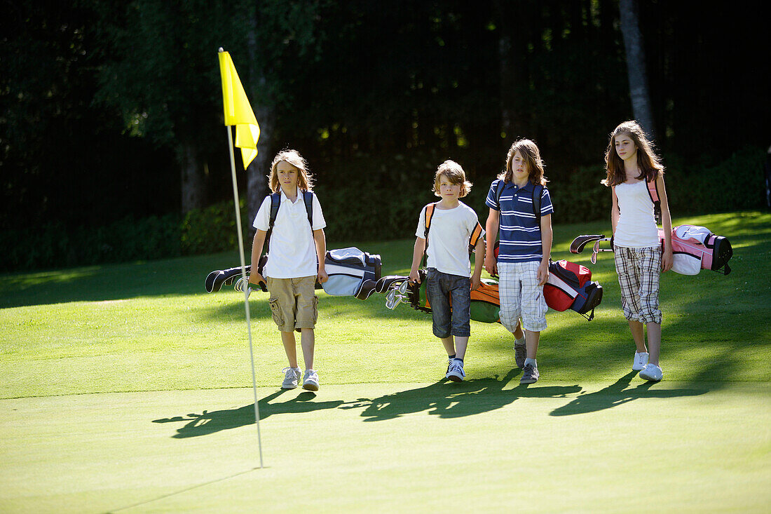 Children playing golf, Bergkramerhof, Bavaria, Germany