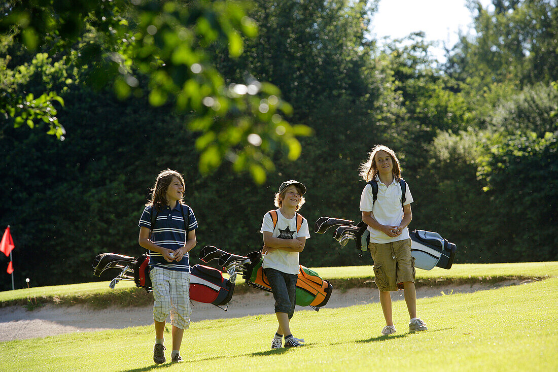 Children playing golf, Bergkramerhof, Bavaria, Germany