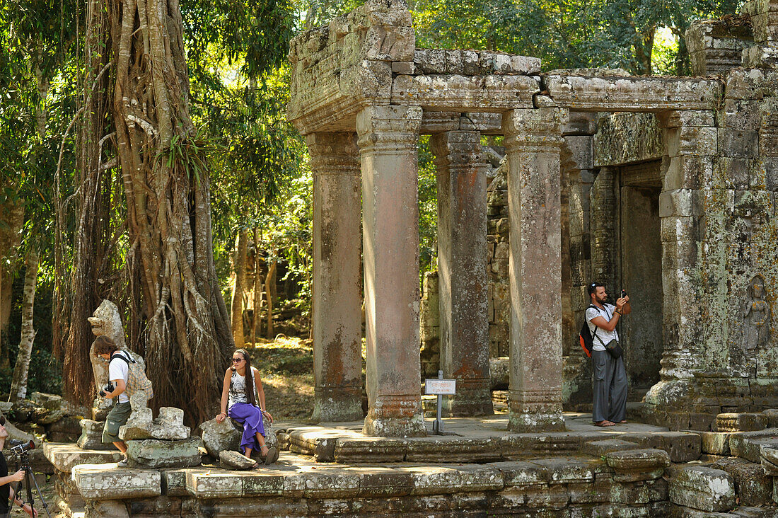 Tourist at the entrance to Preah Khan temple, Angkor, Cambodia, Asia