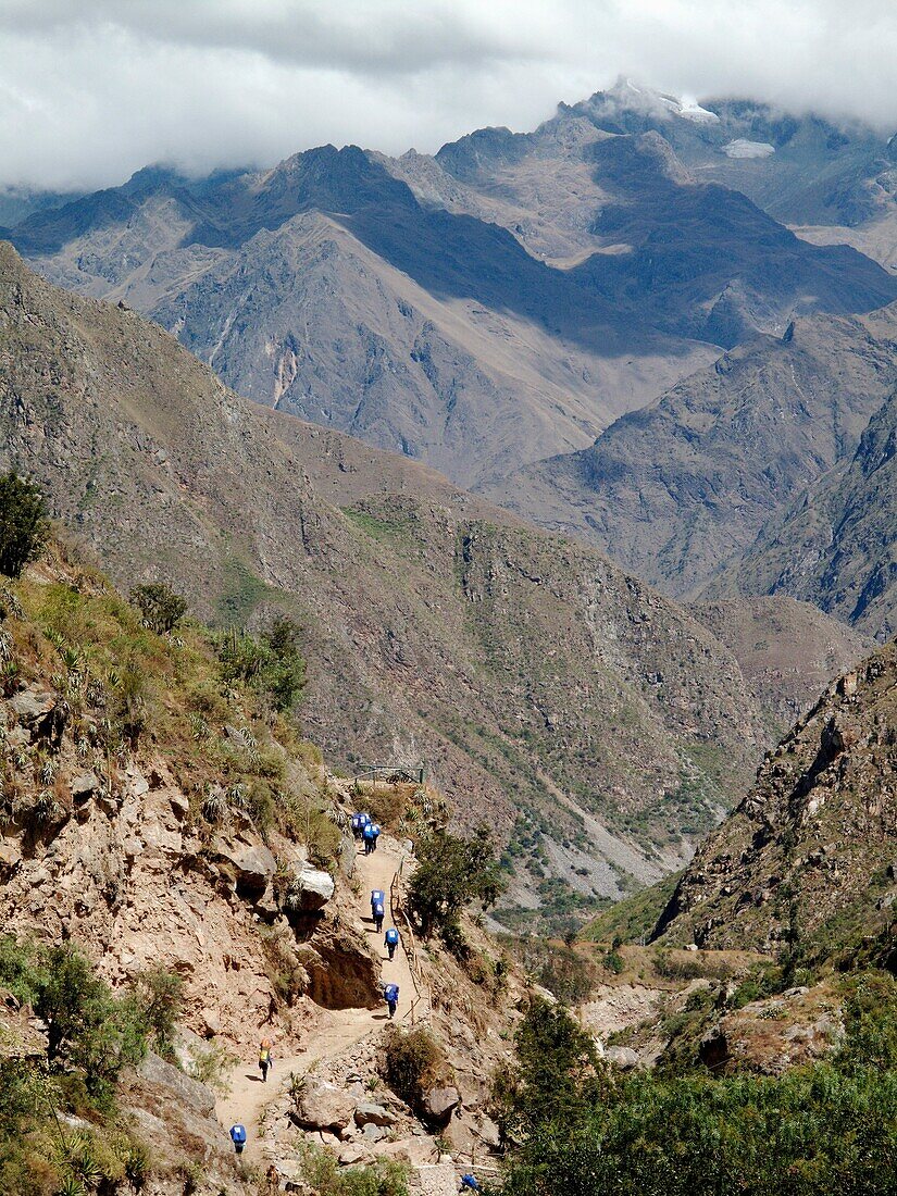 Hikers walk along the famous Inca Trail up the side of the Rio Urubamba valley heading for the ancient ruins at Machu Picchu near Cusco, Peru