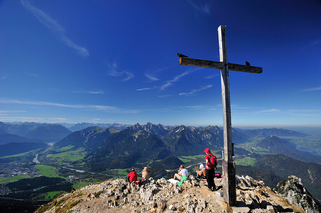 Cross at the summit of Sauling with view to Lech valley and Tannheimer mountain range, Ammergauer Alps, Oberallgaeu, Bavaria, Germany