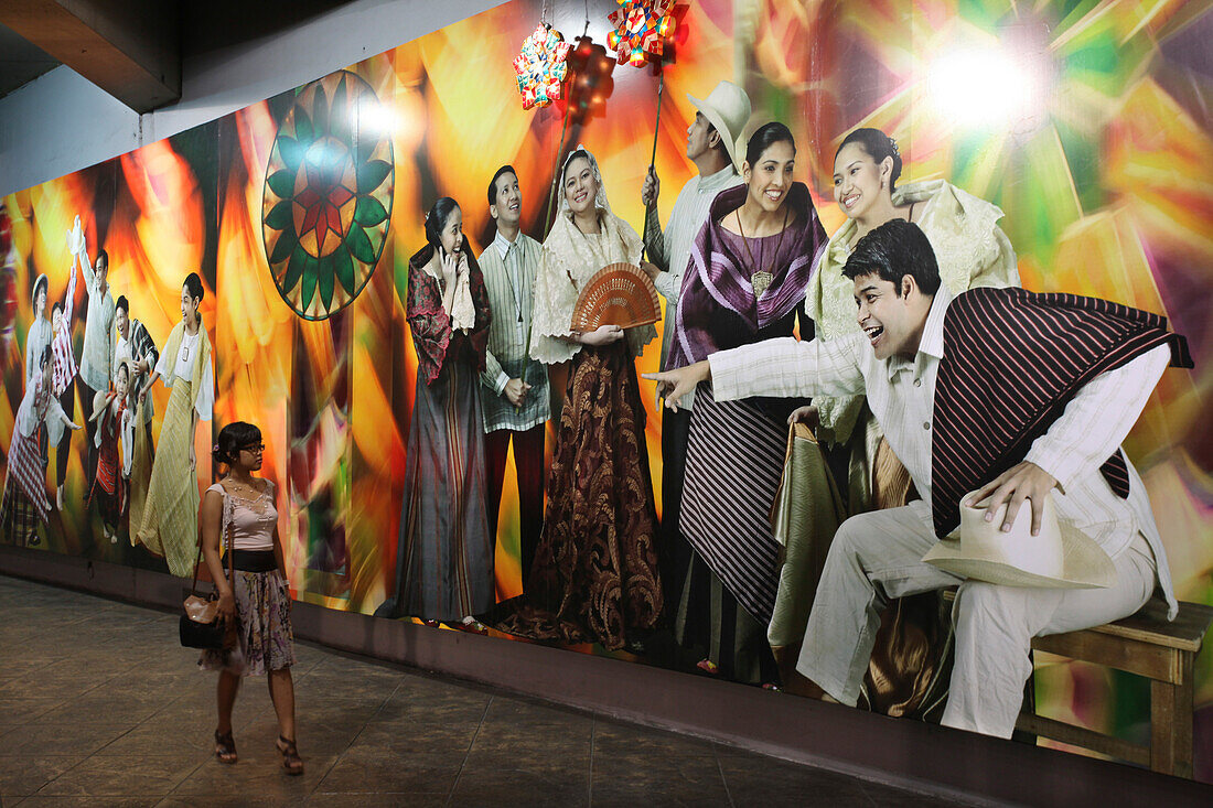 Young woman looking at a wail painting in a tunnel, Makati City, Manila, Luzon Island, Philippines