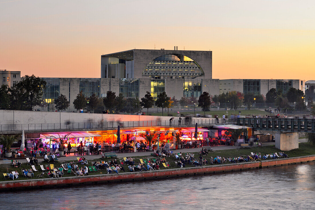 Capital beach cafe at the banks of river Spree, new federal chancellery at dusk, Berlin, Germany, Europe