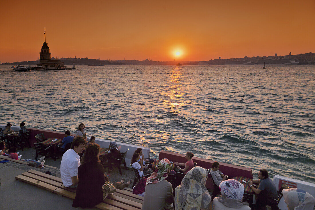 Lounge at Bosporus waterfront, Kis Kulesi tower at sunset, Istanbul, Turkey, Europe