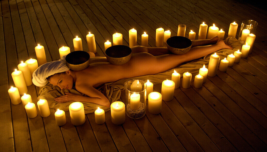 One woman lying in candle circle, Welness hotel, South Tyrol, Trentino-Alto Adige, Italy