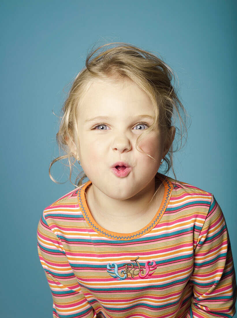 Portrait of little girl making a face