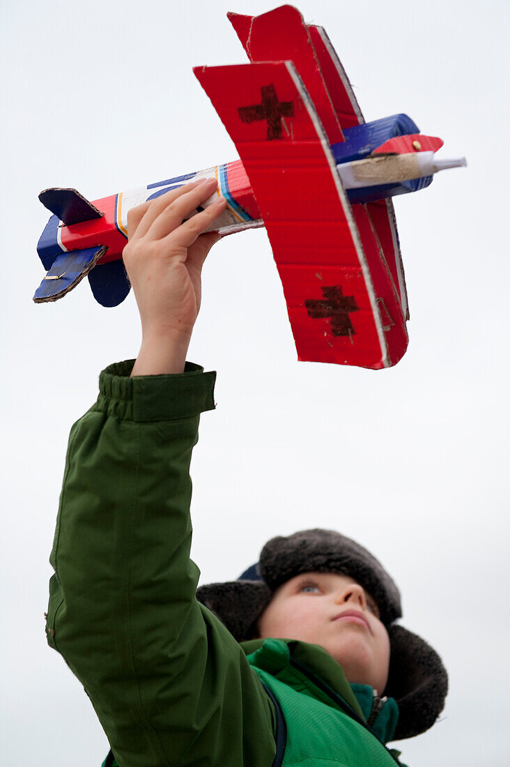 Boy playing with model airplane