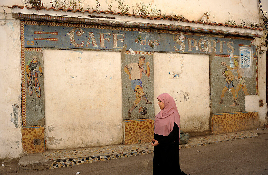 Algeria, Algiers, woman in the street, closed café