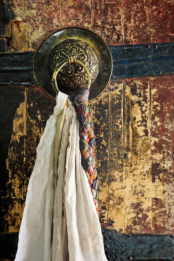 Door knob with silk scarf, khata, Monastery of Thikse, Thiksey, Leh, valley of Indus, Ladakh, Jammu and Kashmir, India
