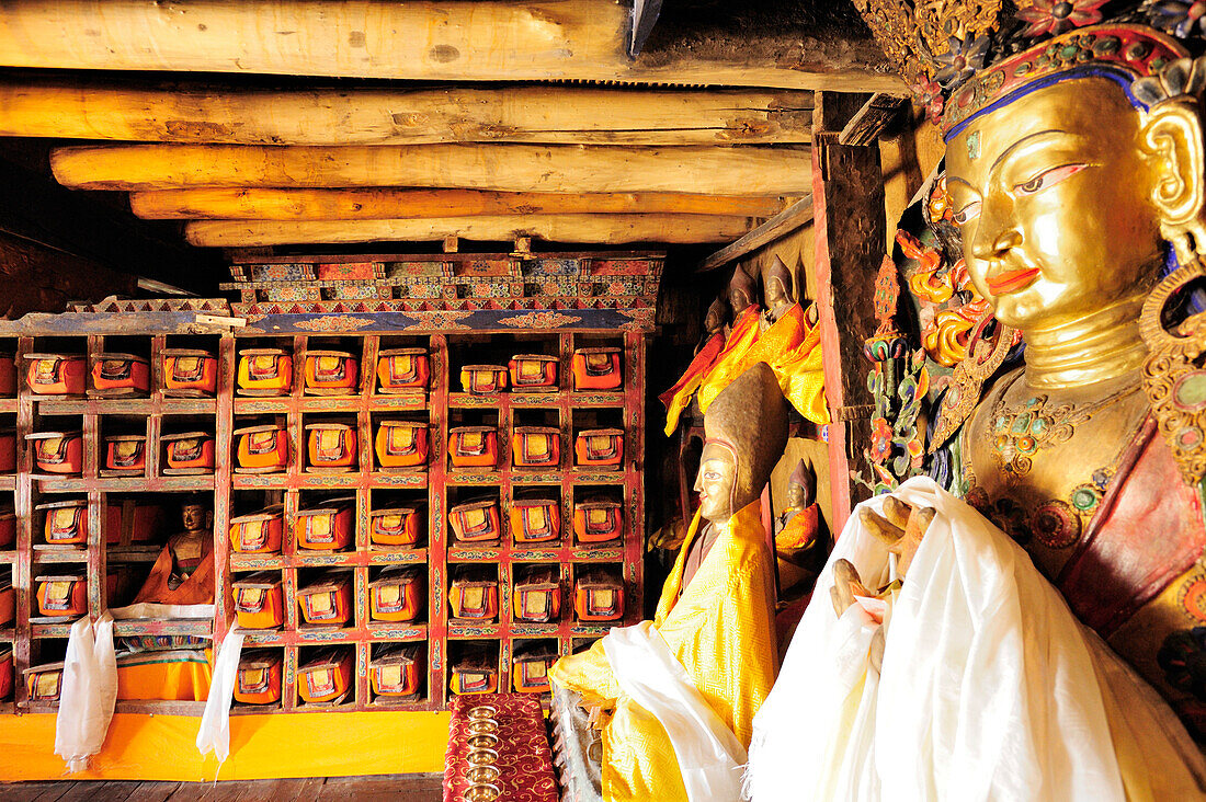 Library with Buddhist books and statues of Buddha, Monastery of Thikse, Thiksey, Leh, valley of Indus, Ladakh, India