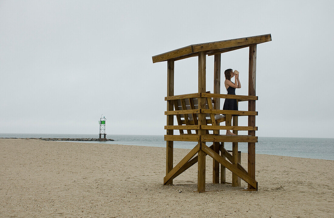 Young Woman Standing in Lifeguard Tower