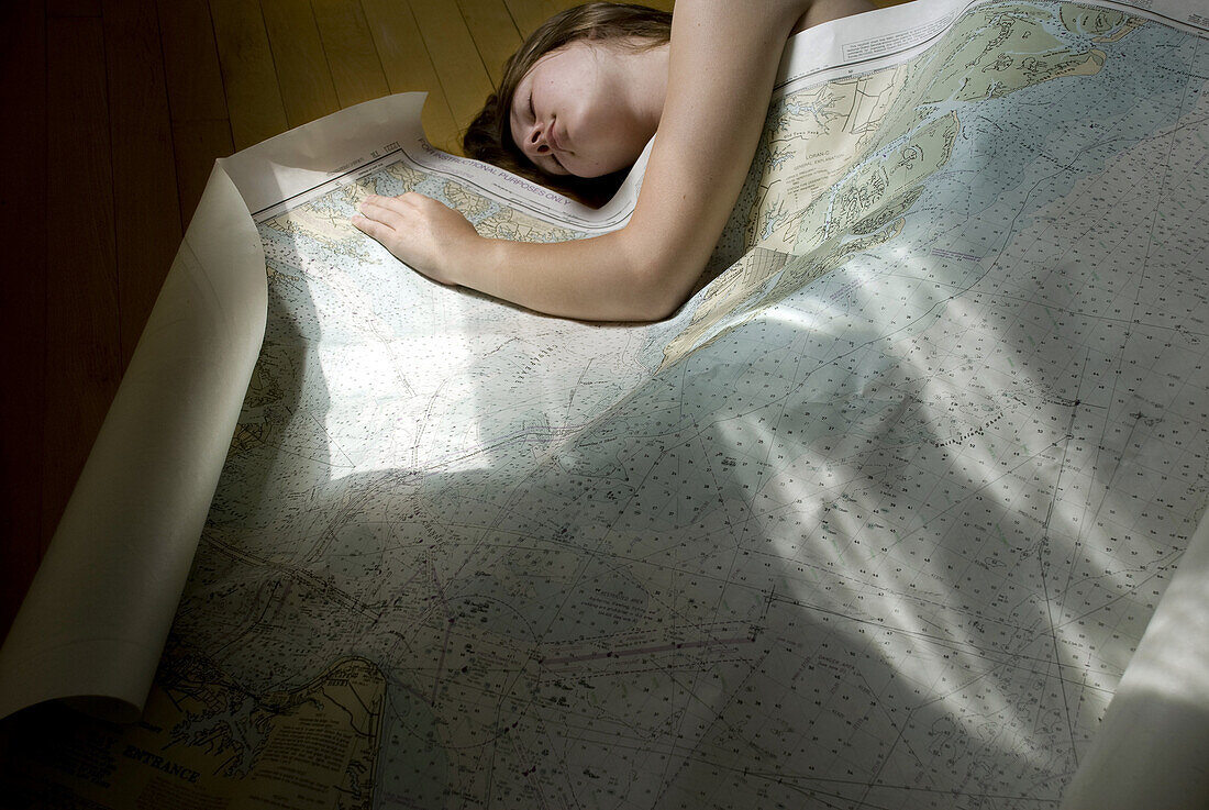 Girl Sleeping Under Map