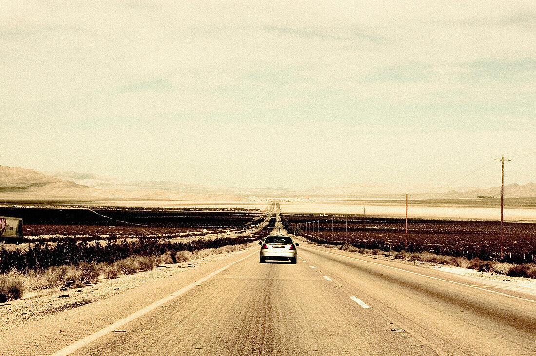 Lone Car on Desert Road, California, USA