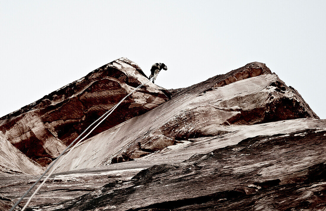 Rock Climber Descending Cliff